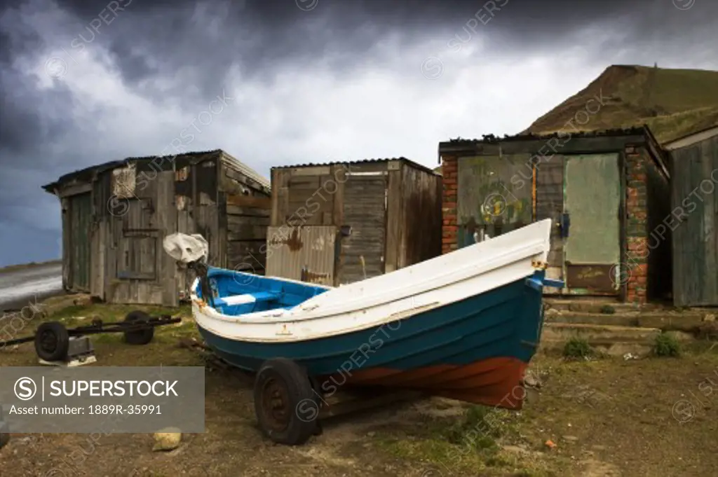 Boat beside old shacks