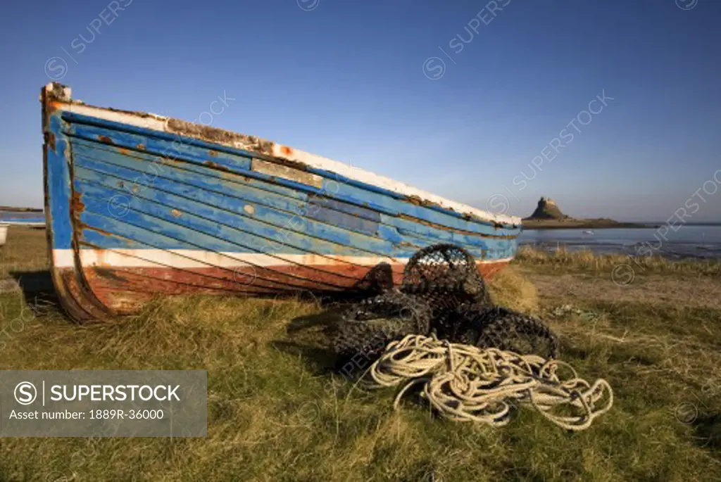 Weathered fishing boat on shore, Holy Island, Bewick, England