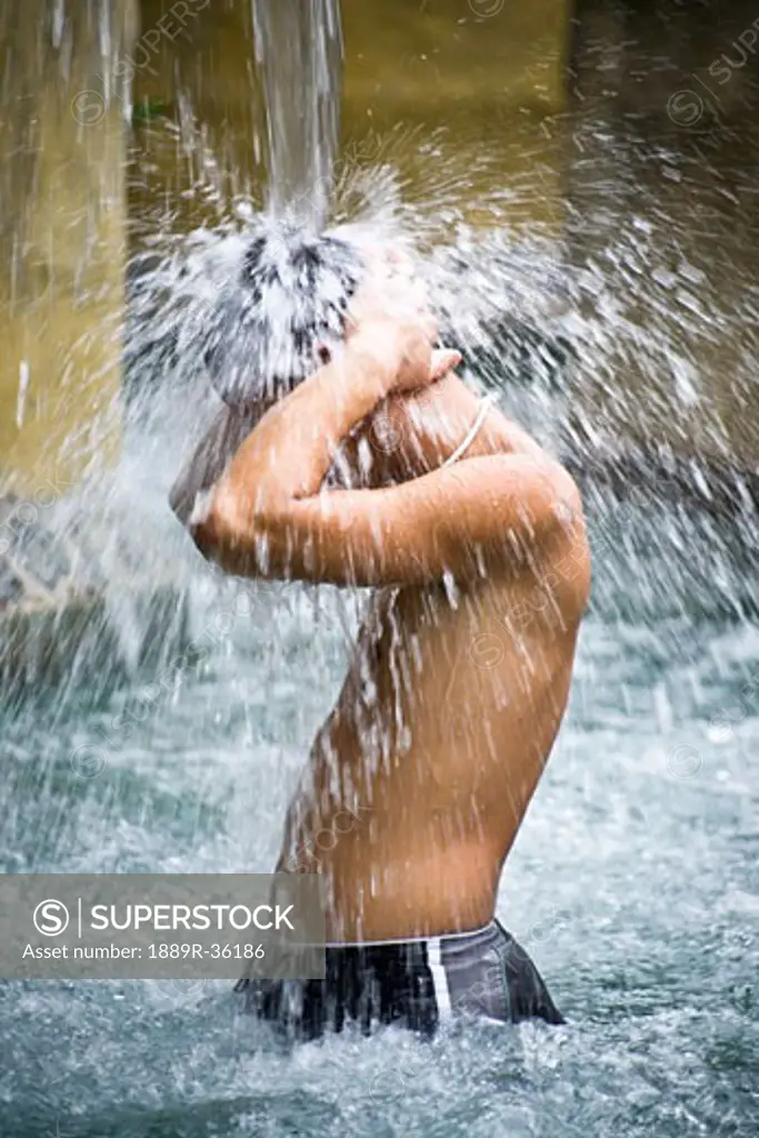 Man under waterfall