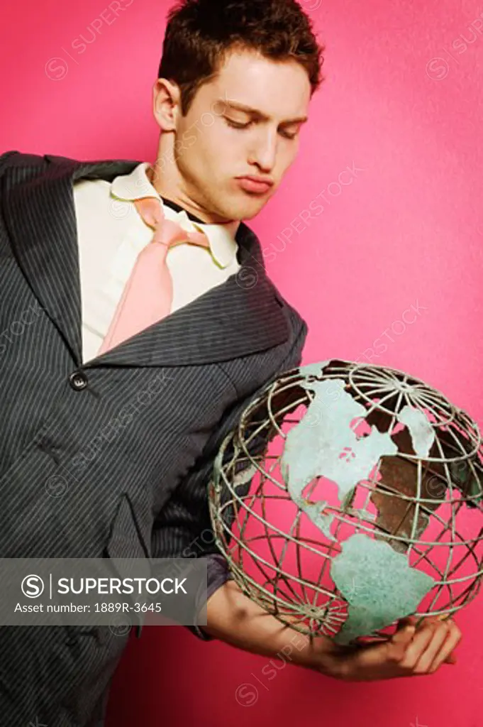 Young businessman with globe in hand
