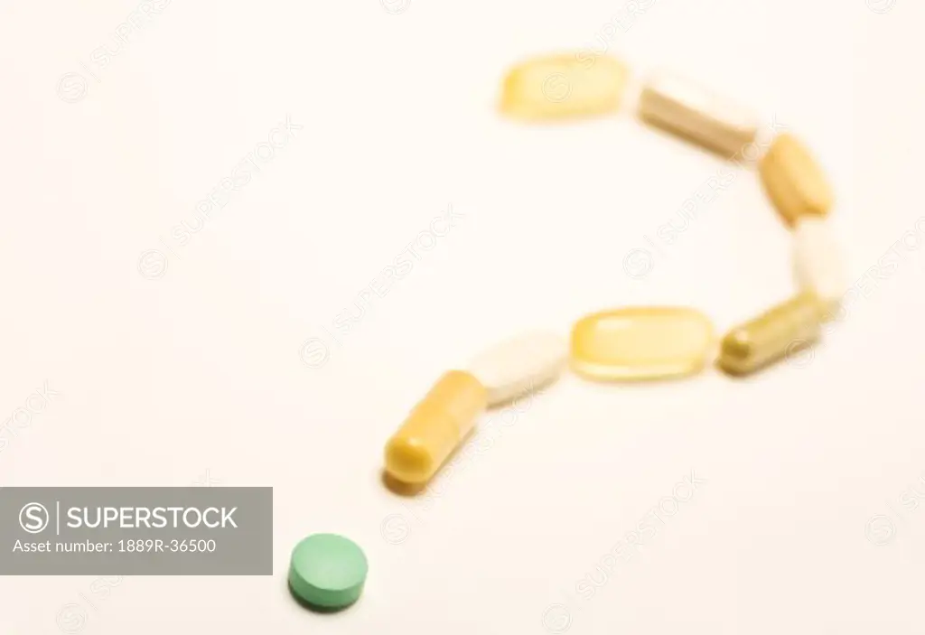 Pill and capsules forming question mark