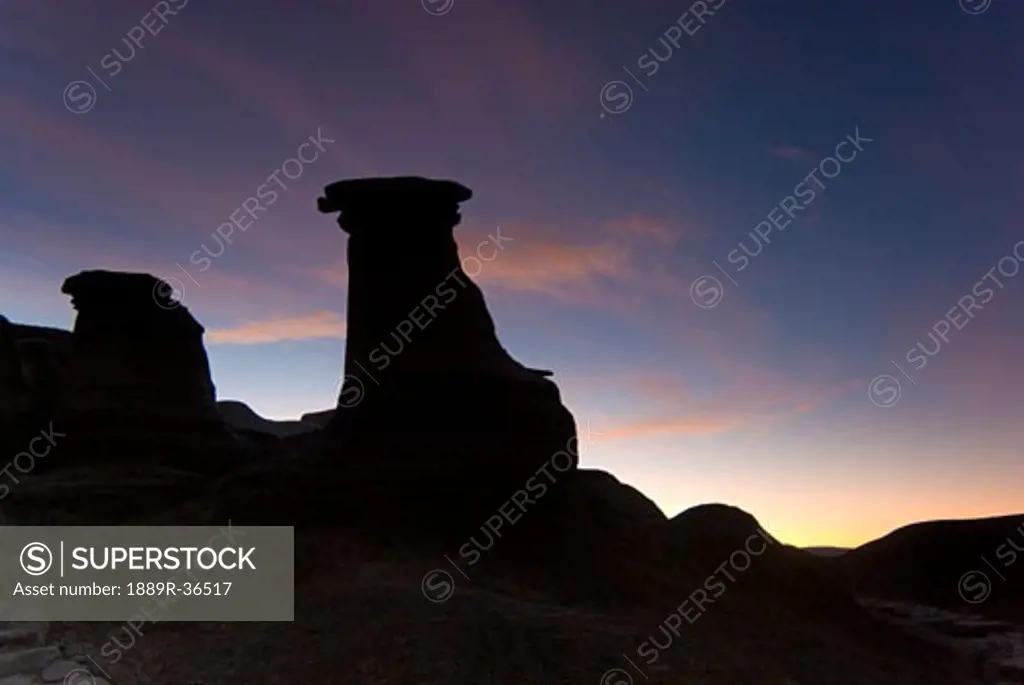 Sunrise over hoodoo rock formations, Drumheller, Alberta, Canada
