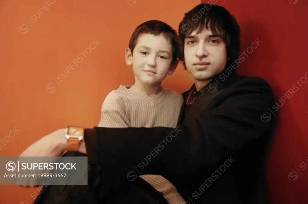 Trendy adult man and young child