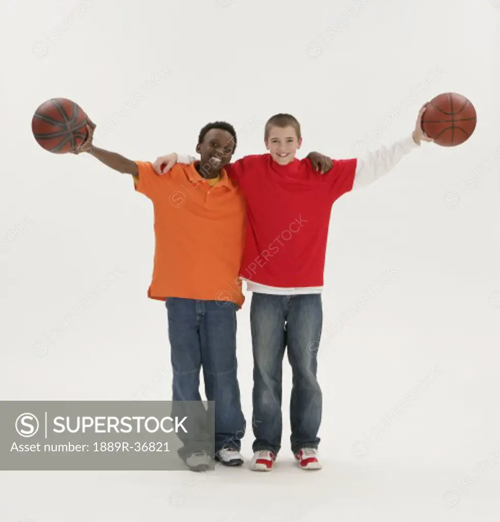 Two boys holding basketballs