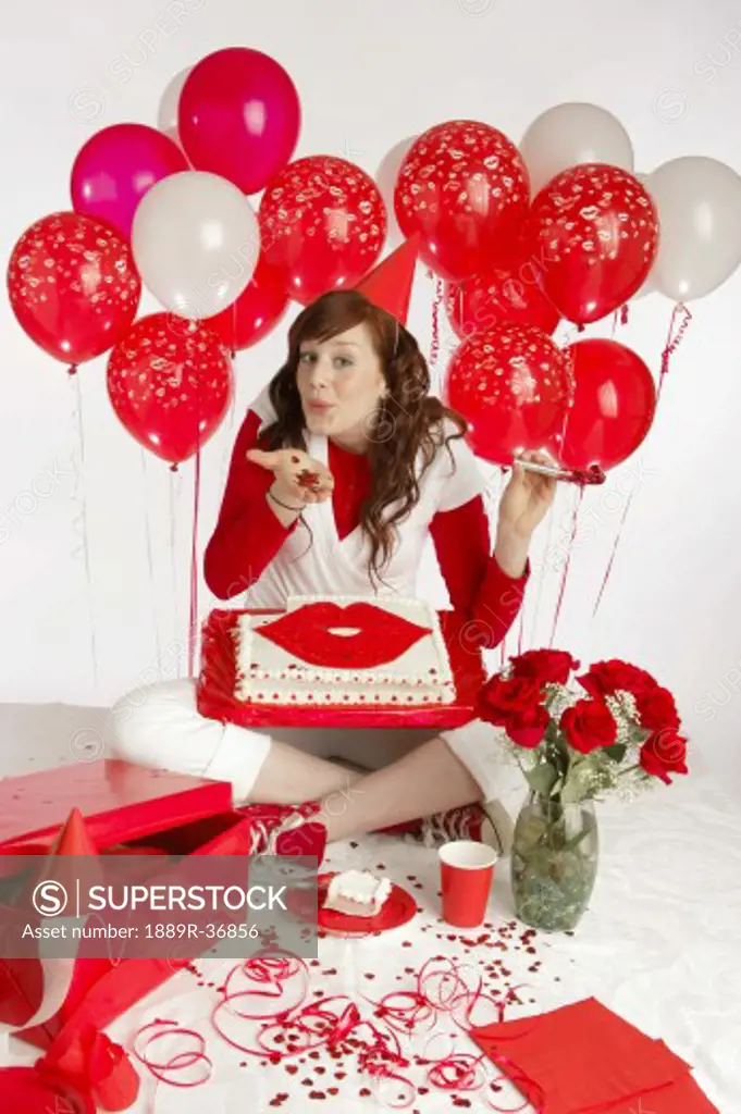 Lady with red balloon's and a cake