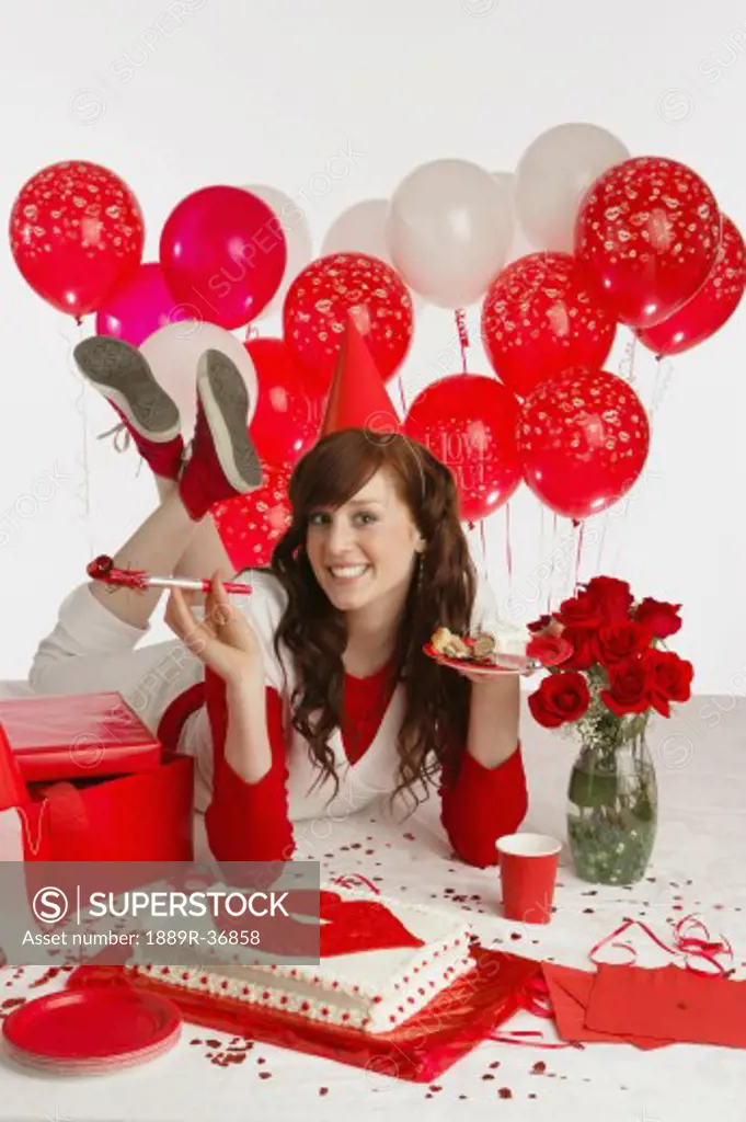 Girl with cake and red balloons