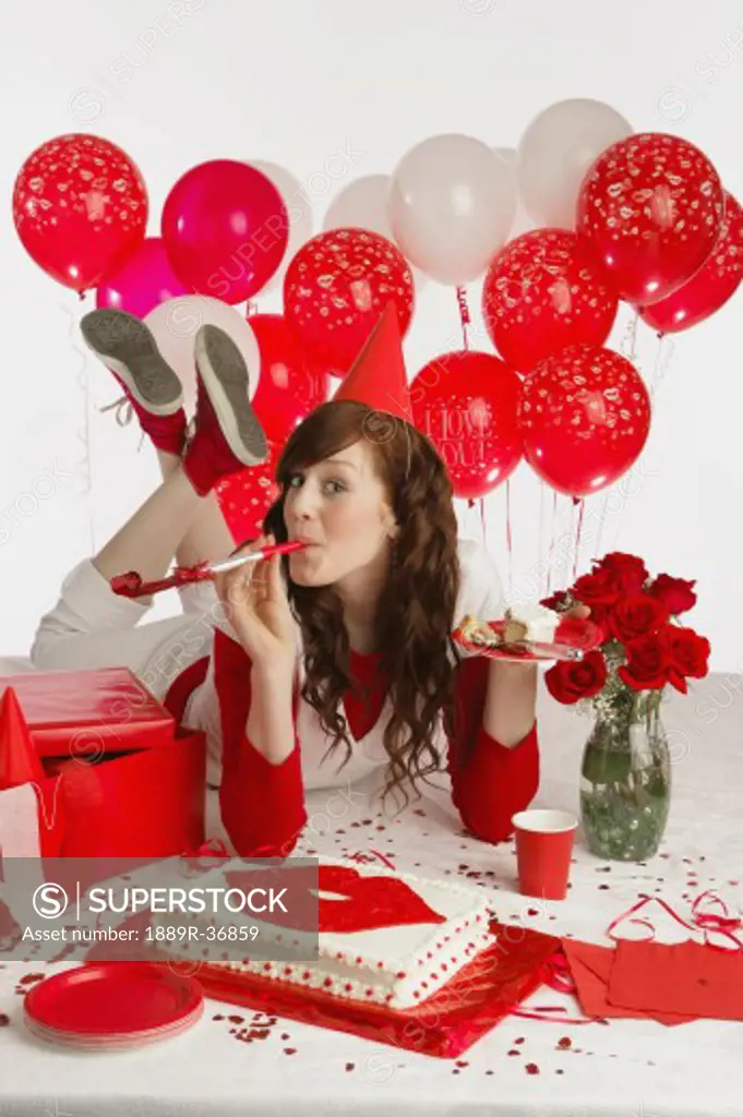 Girl with cake and red balloons
