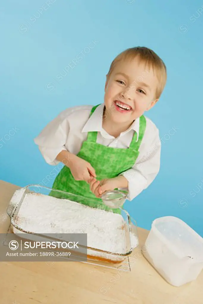 Boy icing a cake