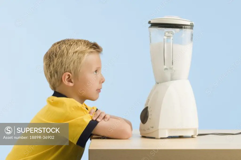 Boy looking at a blender