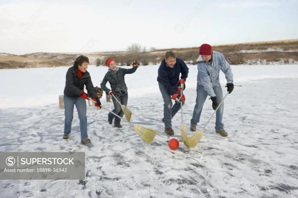 Family playing broomball
