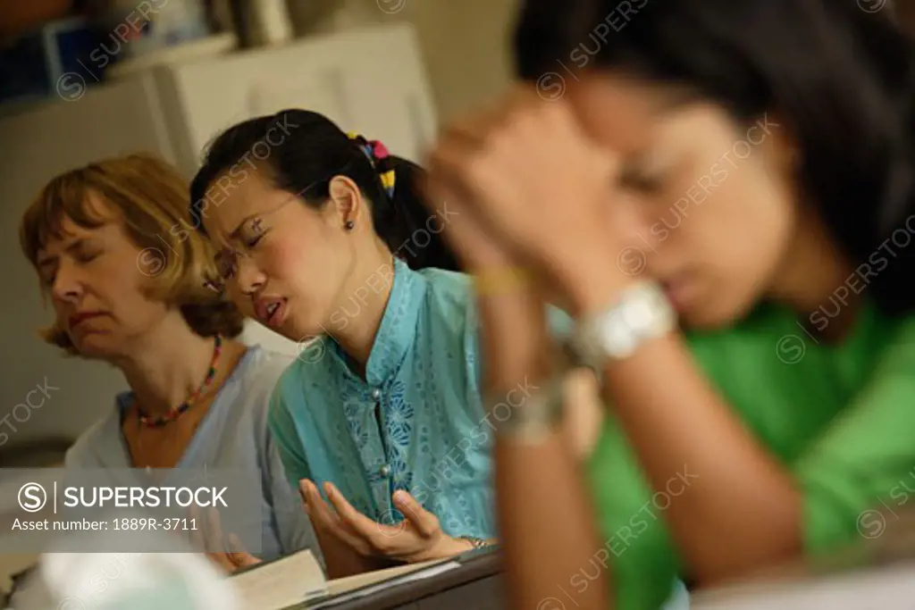 People praying in a classroom