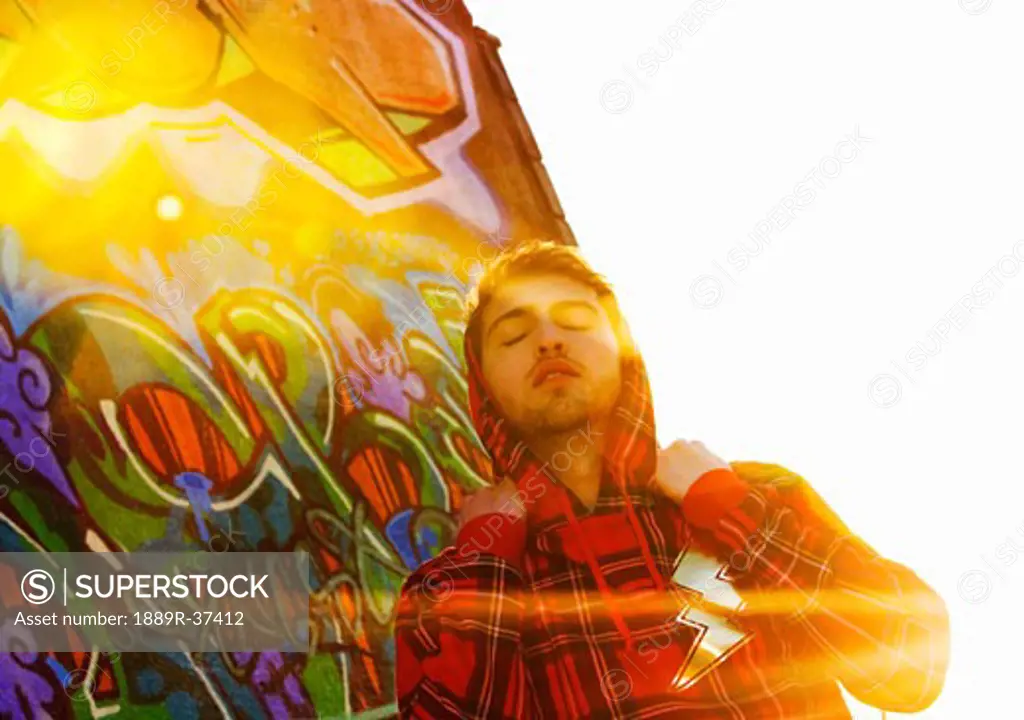 Man in front of graffiti