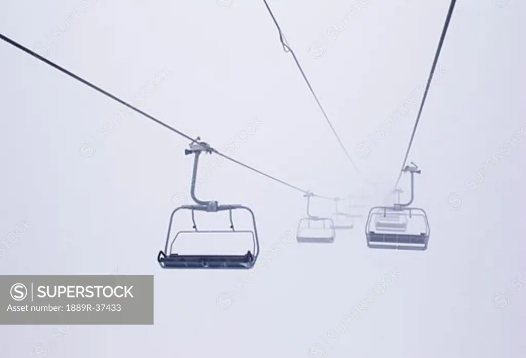 Ski lift chairs in the fog