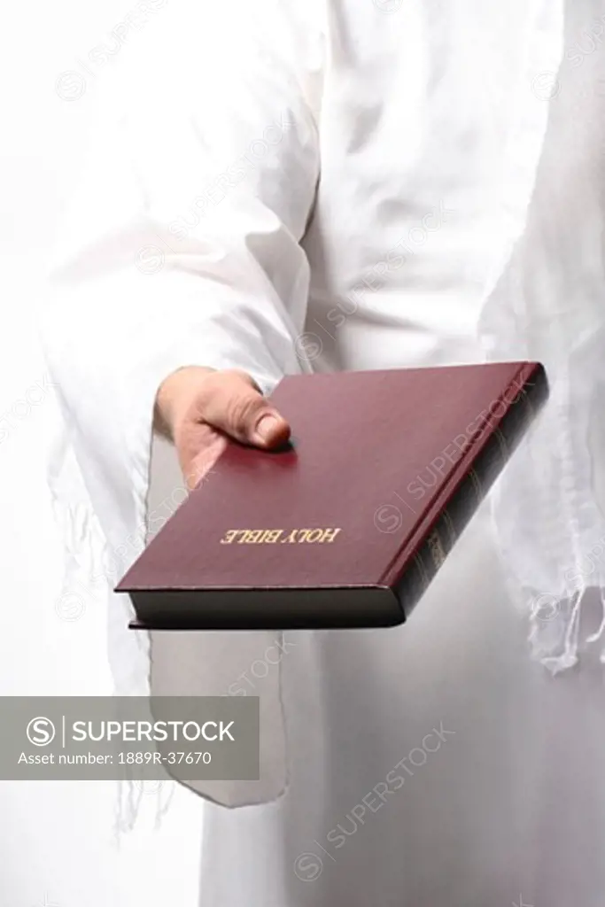 Jesus holding the Bible