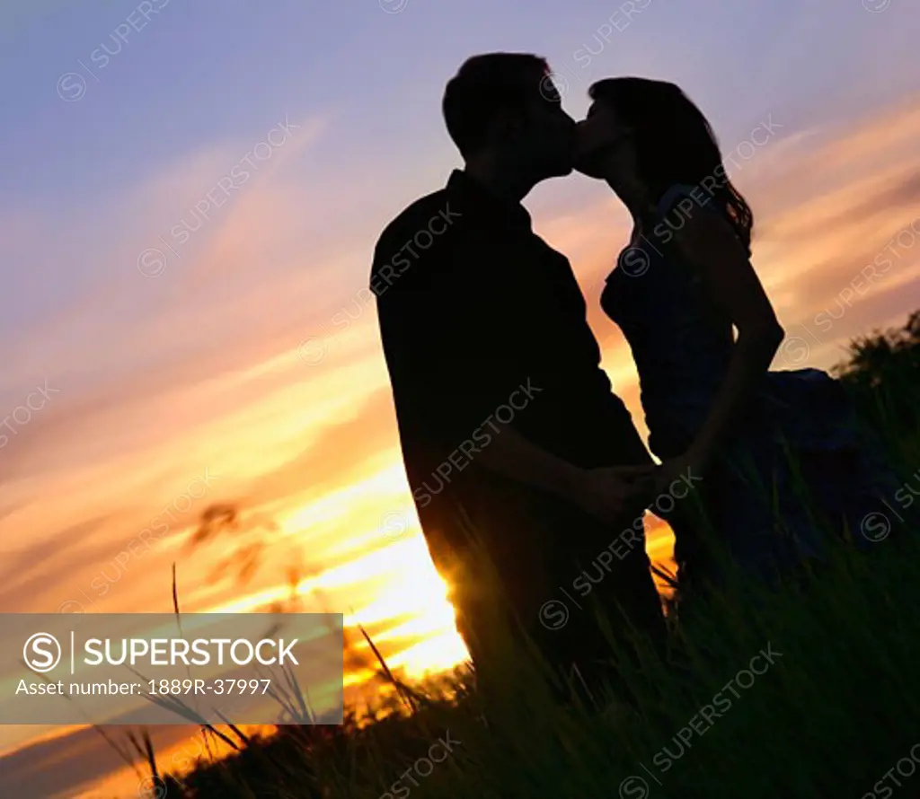Silhouette Of A Couple Kissing