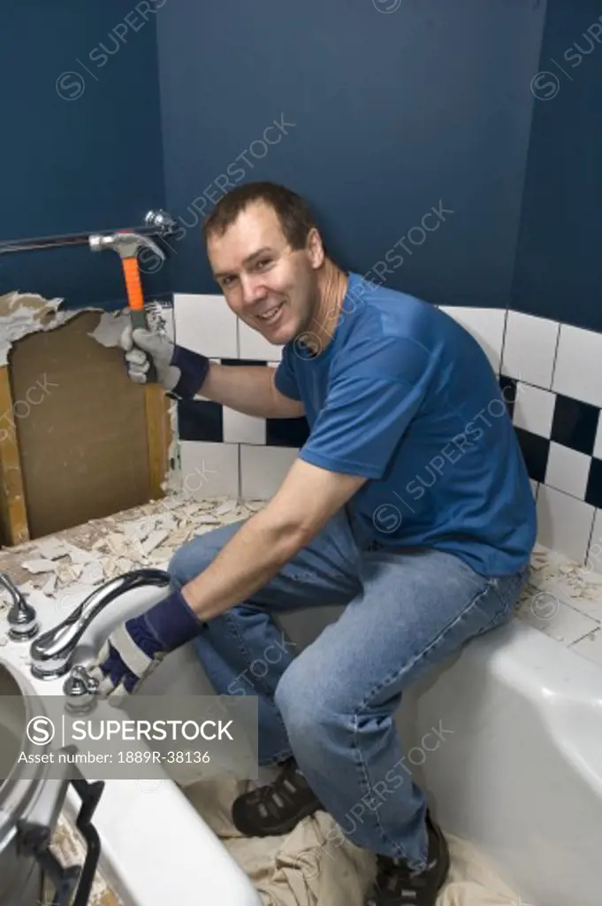 Man fixing bathroom tiles