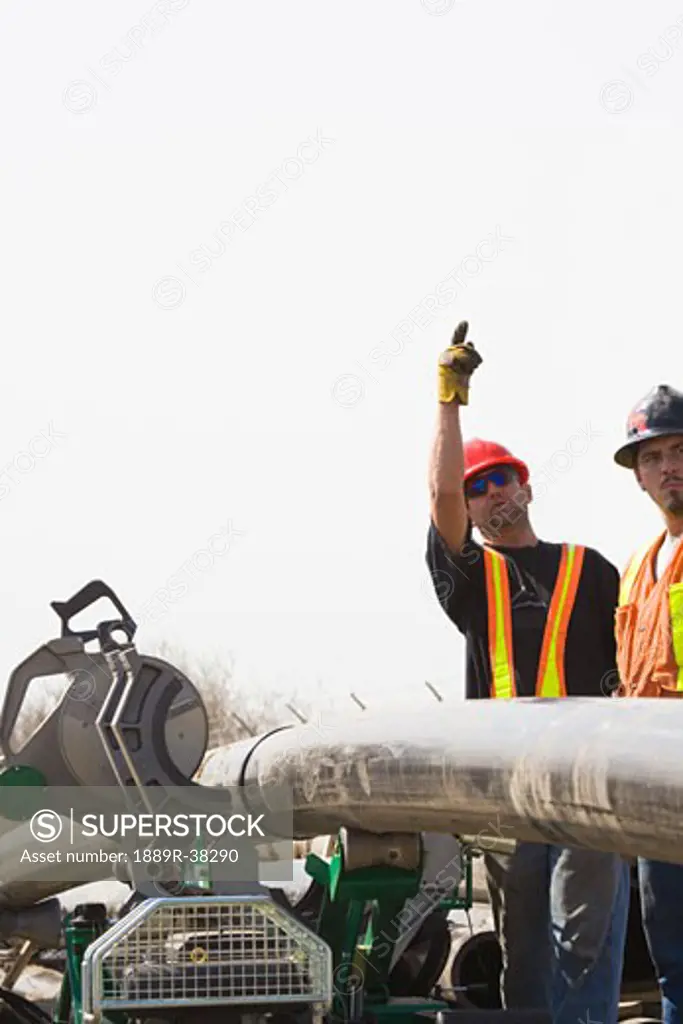 Men at work with hard hats - SuperStock