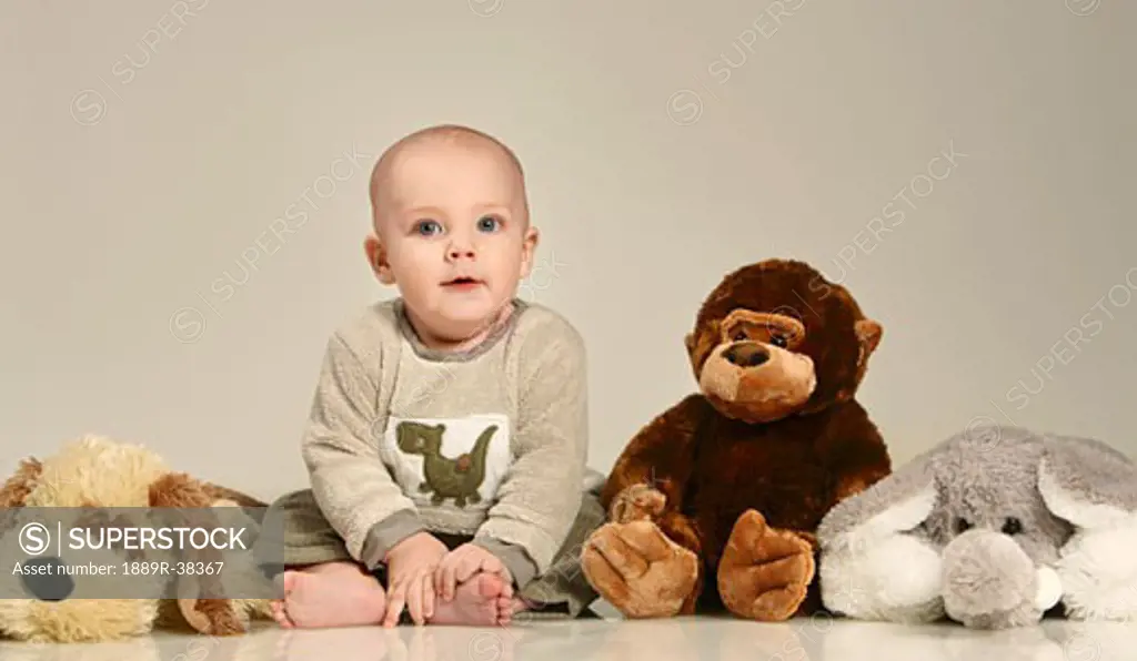 Little boy with stuffed animals