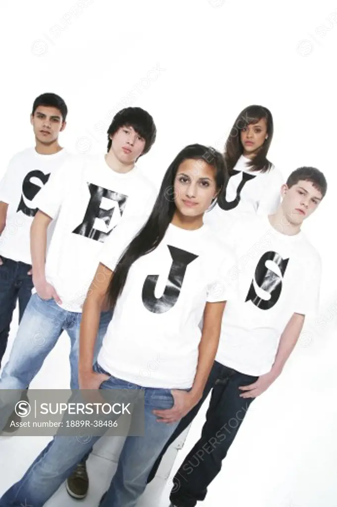 Five teenagers with t-shirts spelling Jesus