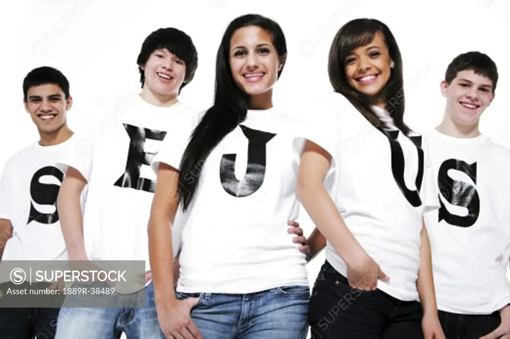 Five teenagers with t-shirts spelling Jesus