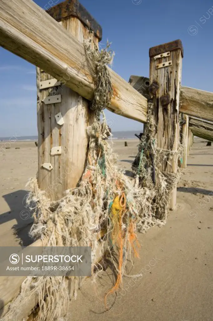 Humberside, England; Derelict wooden fence at the beach