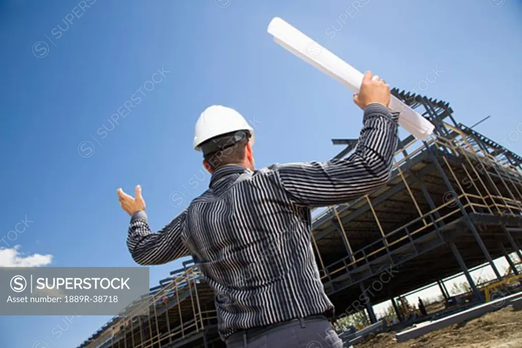 Architect overlooking building site