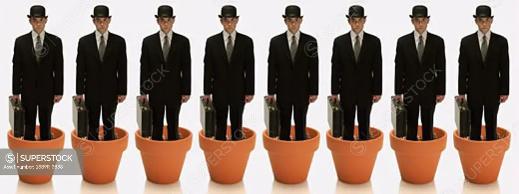 Clones of man in business suit standing in flower pots