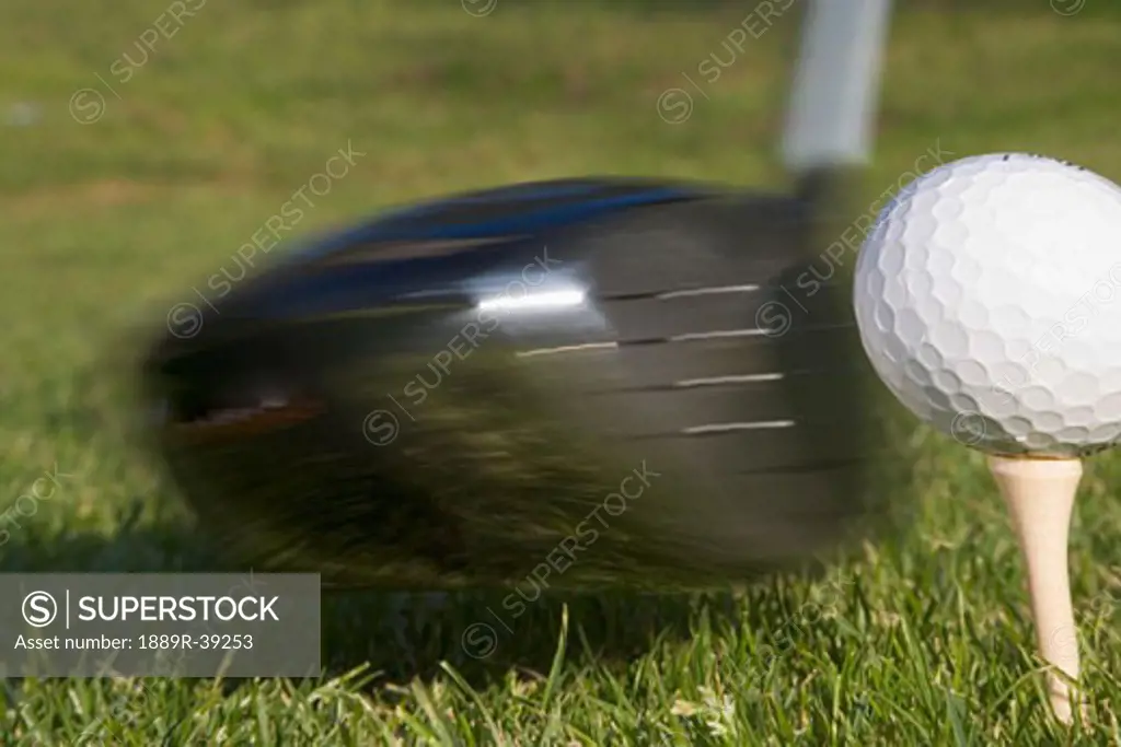 Golf ball on tee hit by driver