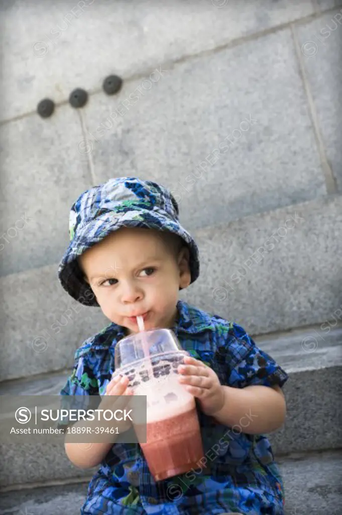 Boy drinking iced fruity drink