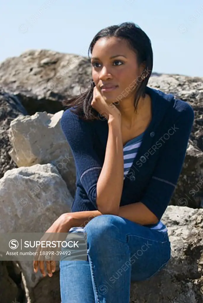 Woman sitting on rocks  