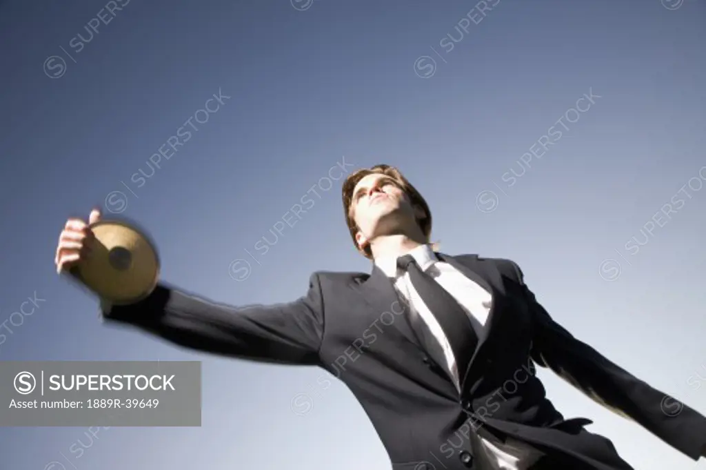 Businessman throwing a discus