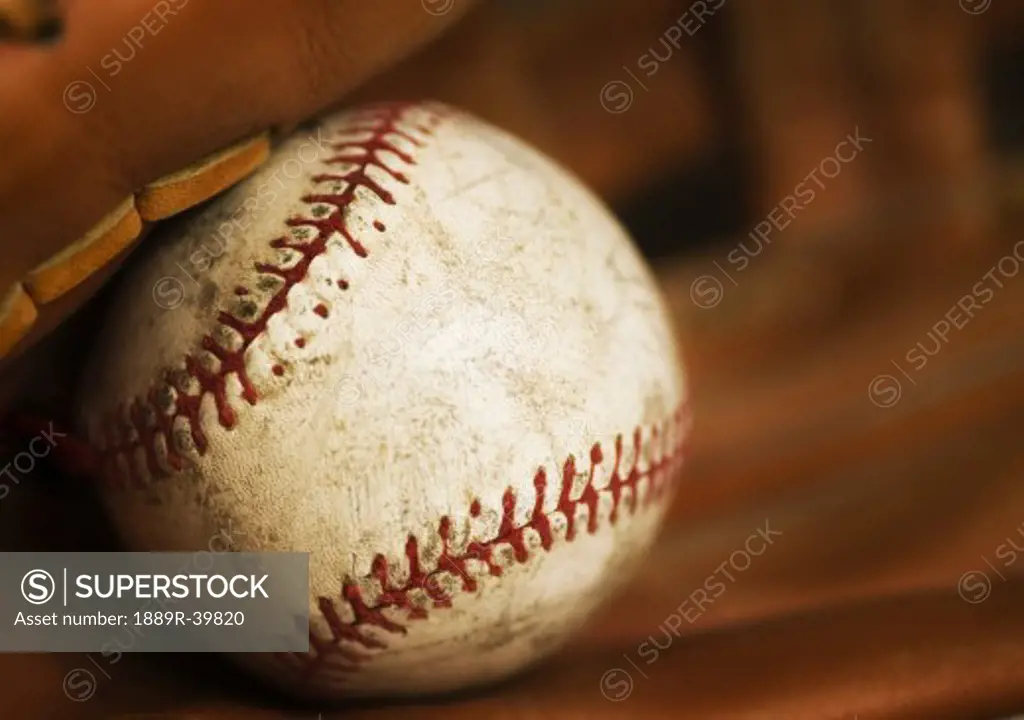 Close up of a baseball in a glove