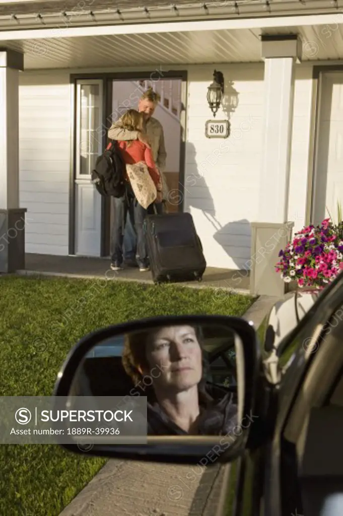 Young woman visiting dad with mom looking on