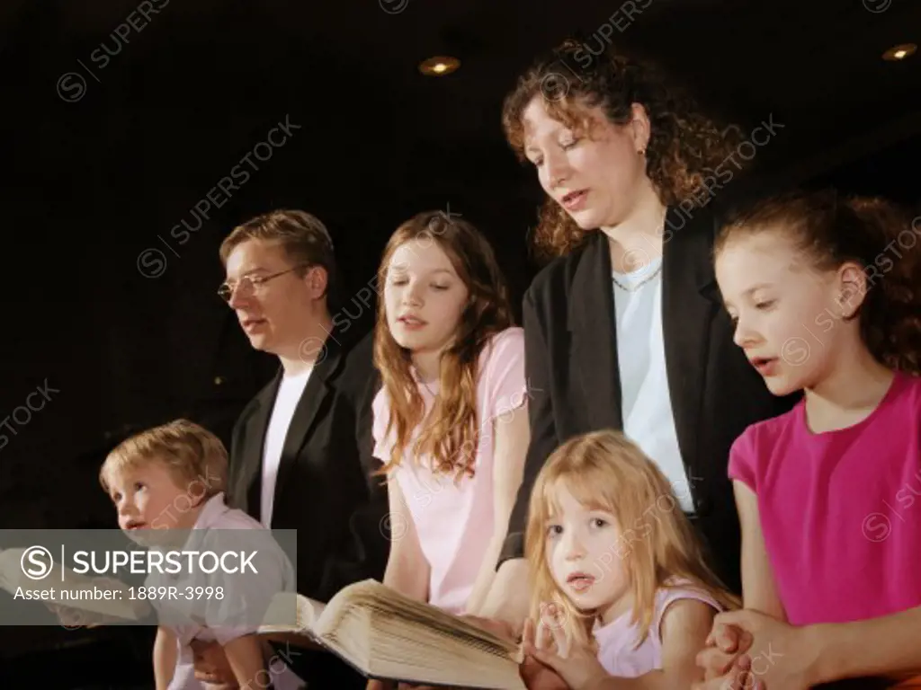 Family singing at Mass