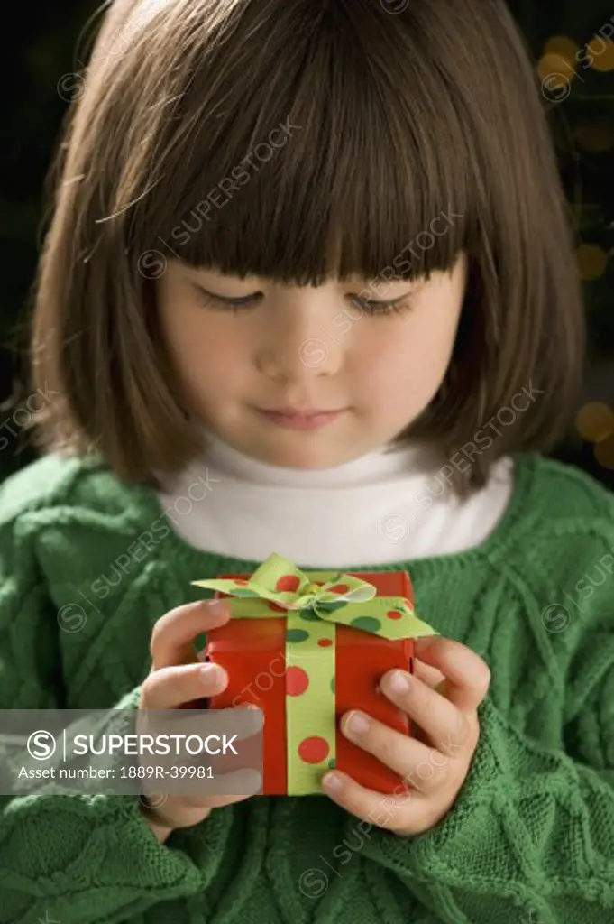 Little girl holding a present