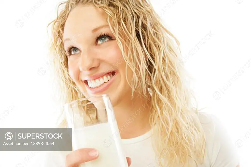 Pretty girl drinking a glass of milk
