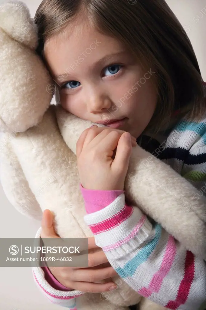 Girl hugging teddy bear
