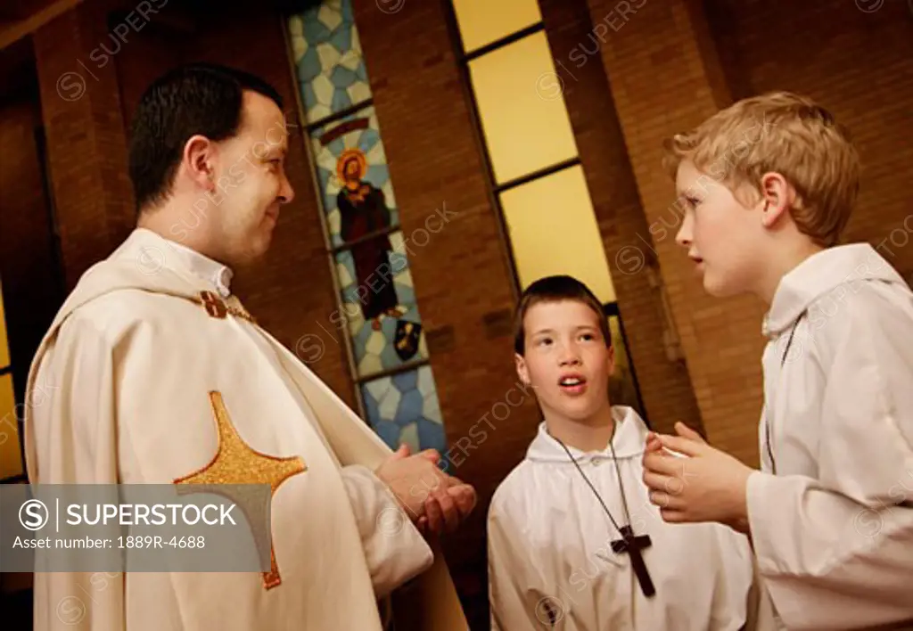 Priest talking to the altar boys