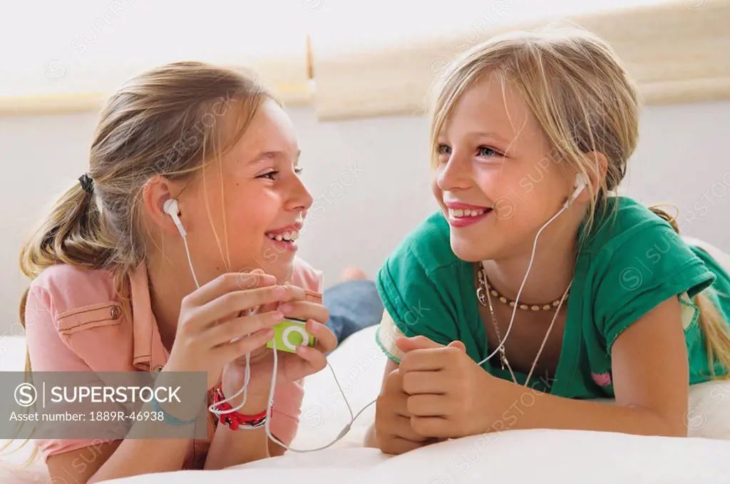 Two girls listening to music player