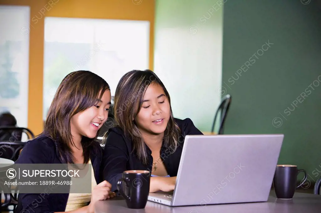 Two girls on a laptop computer