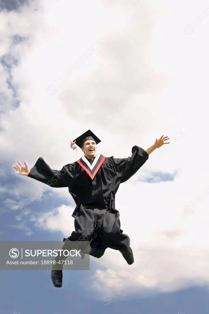 Excited graduate jumping for joy