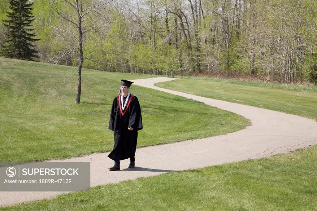 Graduate walking a path