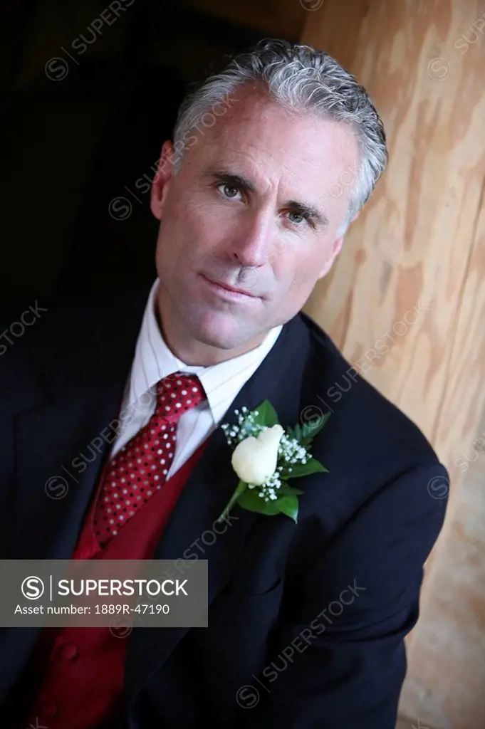 Man in a suit with flower on his lapel