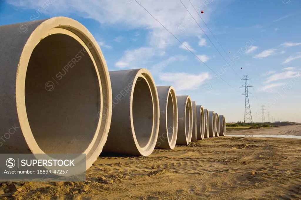 Sewer pipes ready to be installed in highway