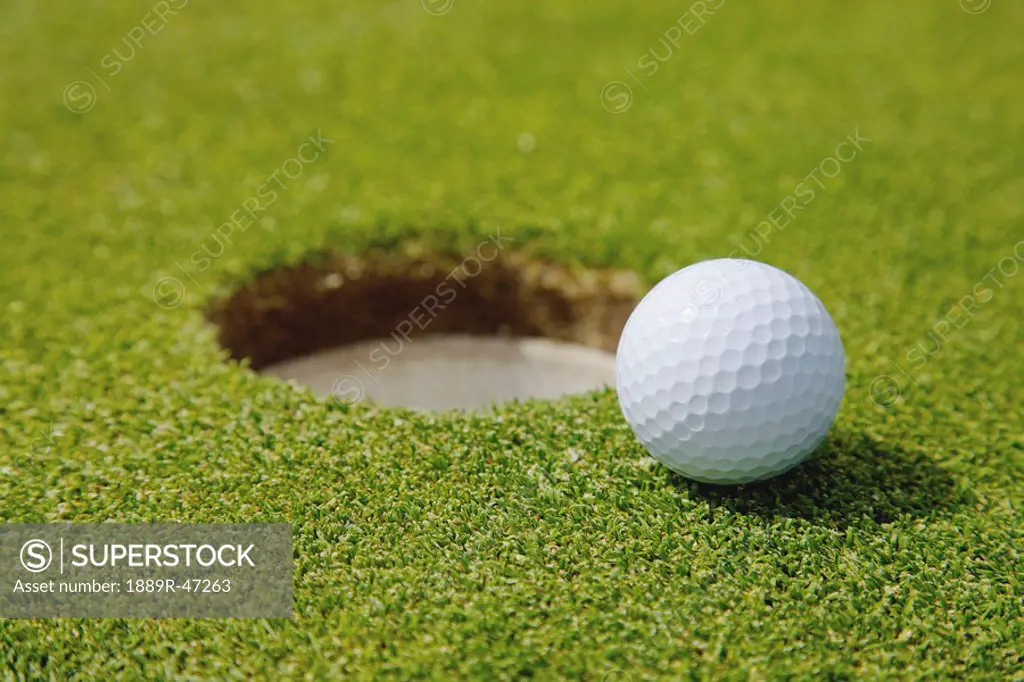 Golf ball near a hole