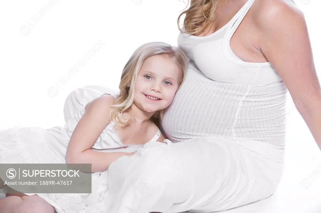 Pregnant woman sitting with her daughter