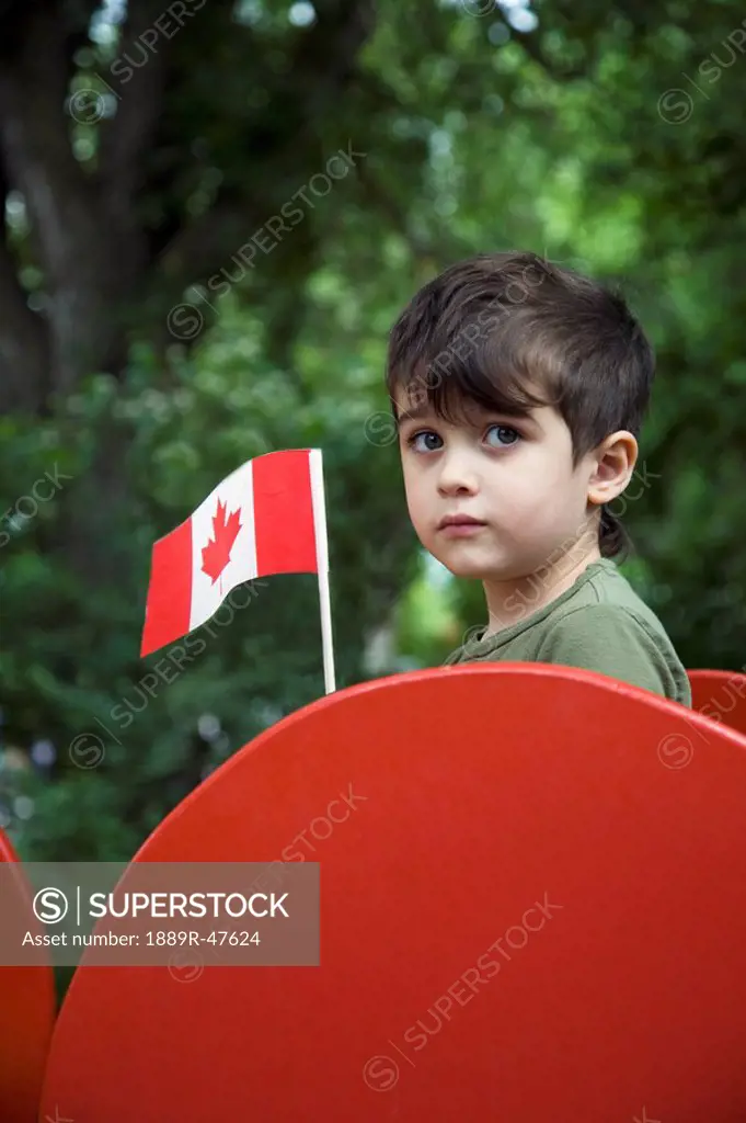 Boy holding a Canadian flag