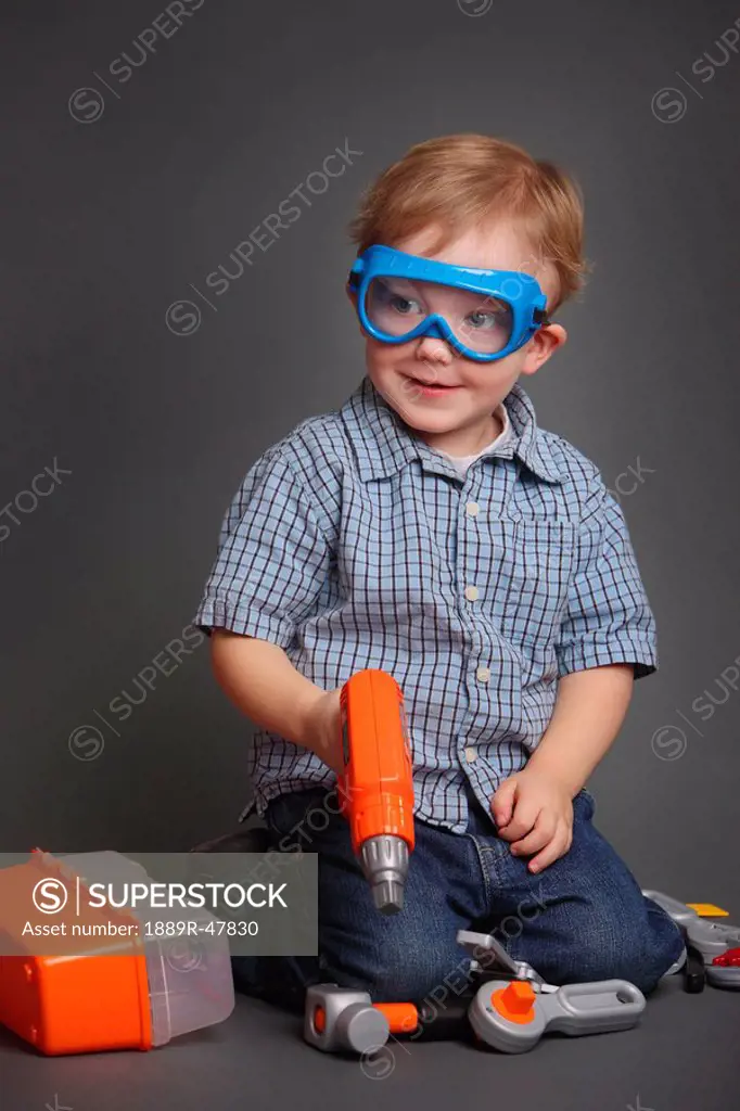Boy playing with play tools