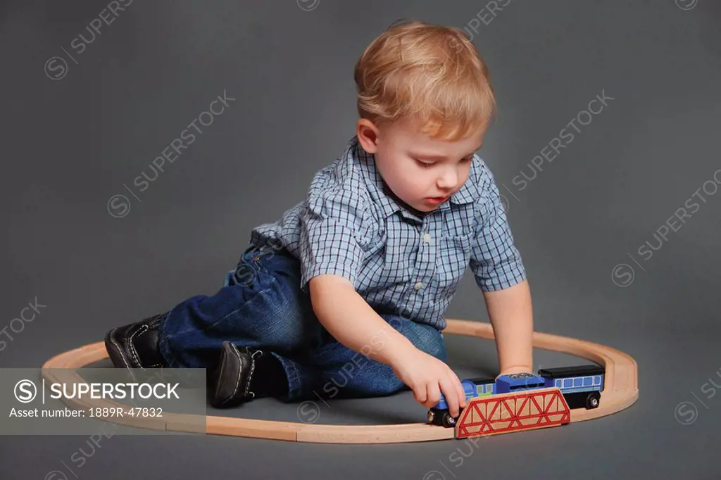 Boy playing with toy train