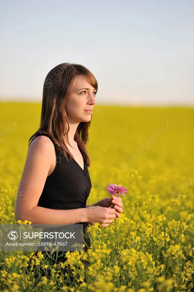 Young woman in a canola field